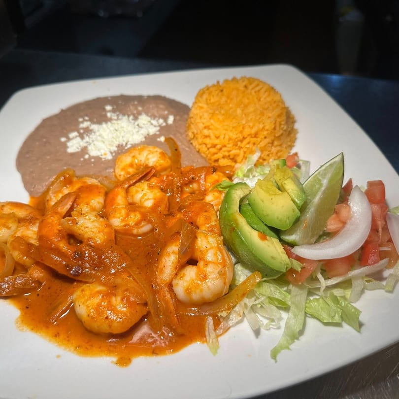 A plate of Javi Mexican Grill's camarones a la diabla with rice, refried beans, and salad.